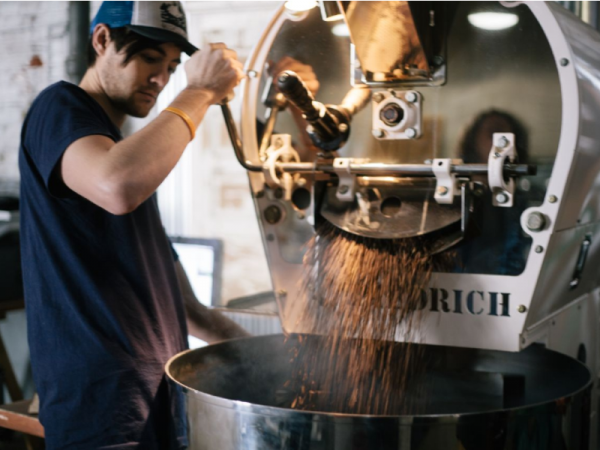 A man roasting coffee at Elixr coffee roasters.